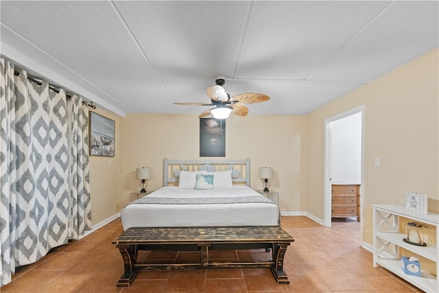 tiled bedroom featuring ceiling fan