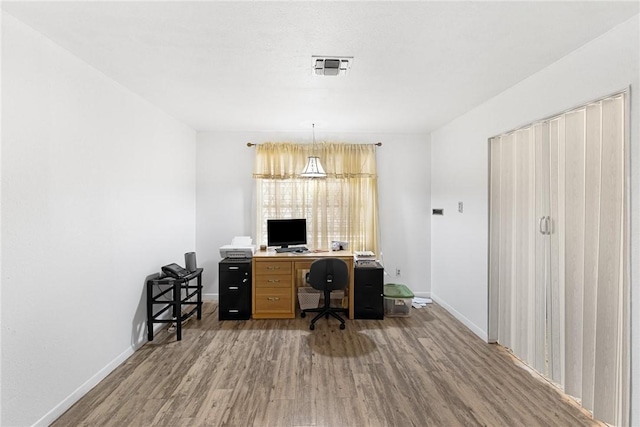 office with hardwood / wood-style flooring