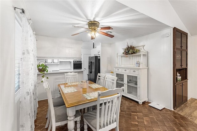 dining room featuring lofted ceiling and ceiling fan