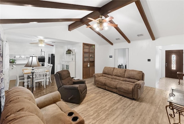 living room featuring lofted ceiling with beams, ceiling fan, and light hardwood / wood-style flooring