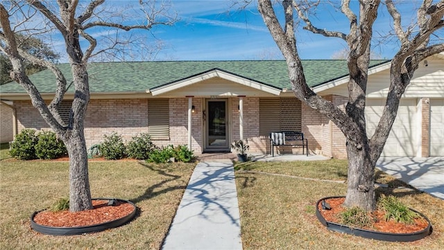 single story home featuring a garage and a front yard