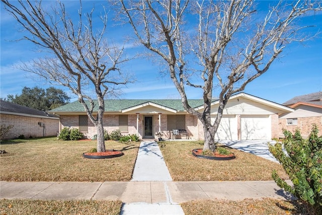 single story home with a garage, covered porch, and a front yard