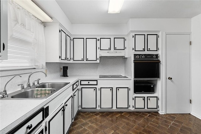 kitchen with sink, decorative backsplash, and black appliances