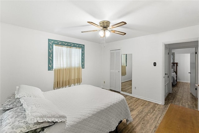 bedroom featuring hardwood / wood-style flooring, ceiling fan, and a closet