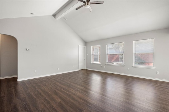 spare room with arched walkways, ceiling fan, dark wood-style flooring, and lofted ceiling with beams