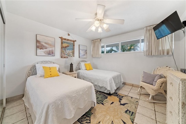 bedroom featuring ceiling fan and light tile patterned flooring