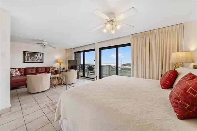 bedroom featuring access to exterior, light tile patterned floors, and ceiling fan