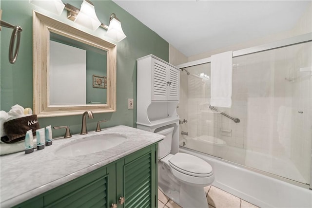 full bathroom featuring toilet, vanity, tile patterned floors, and enclosed tub / shower combo