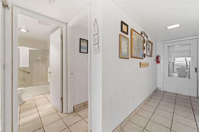 corridor with light tile patterned floors