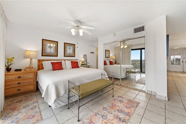 bedroom featuring tile patterned floors, ceiling fan, and a closet