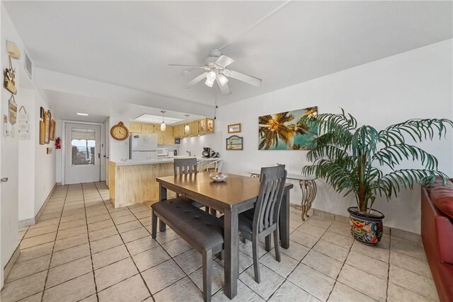 dining space featuring light tile patterned floors and ceiling fan