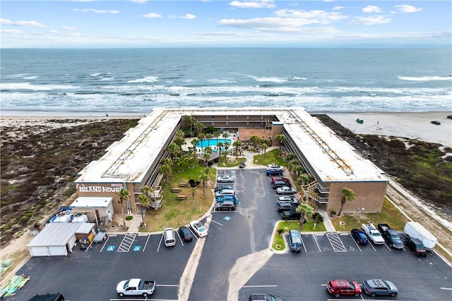 birds eye view of property featuring a water view and a view of the beach