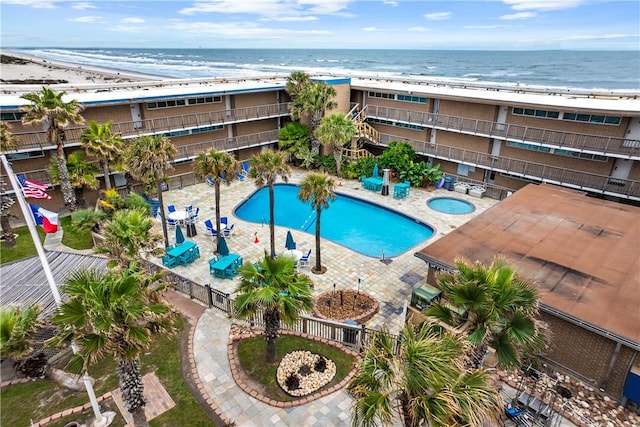 view of swimming pool with a view of the beach and a water view