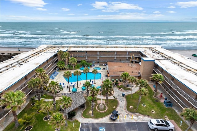 drone / aerial view with a water view and a beach view