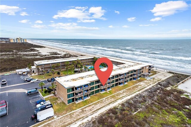 drone / aerial view featuring a view of the beach and a water view