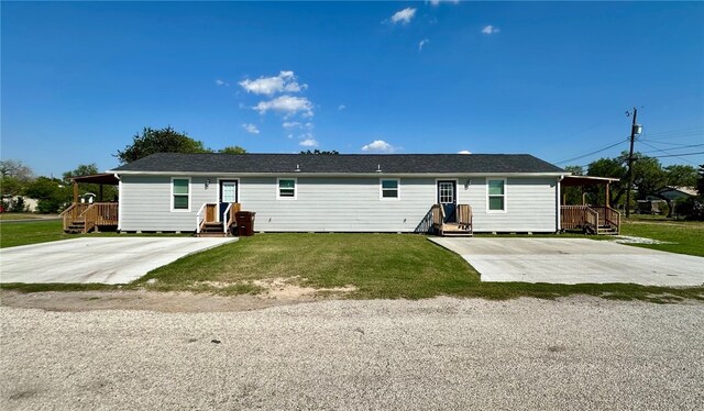 rear view of property with a lawn