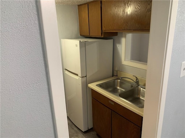 kitchen with white refrigerator and sink