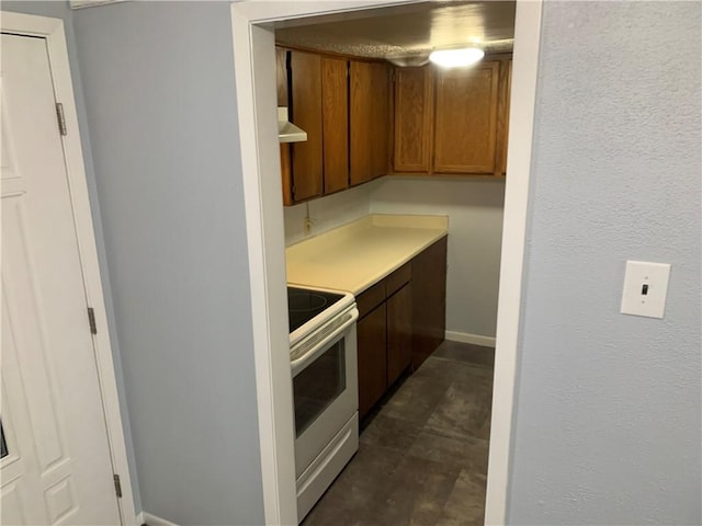 kitchen with white electric range oven and exhaust hood