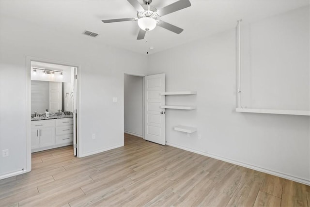 15101 Tesoro Dr, Corpus Christi, TX 78418 - unfurnished bedroom with light wood-type flooring, ensuite bath, and ceiling fan