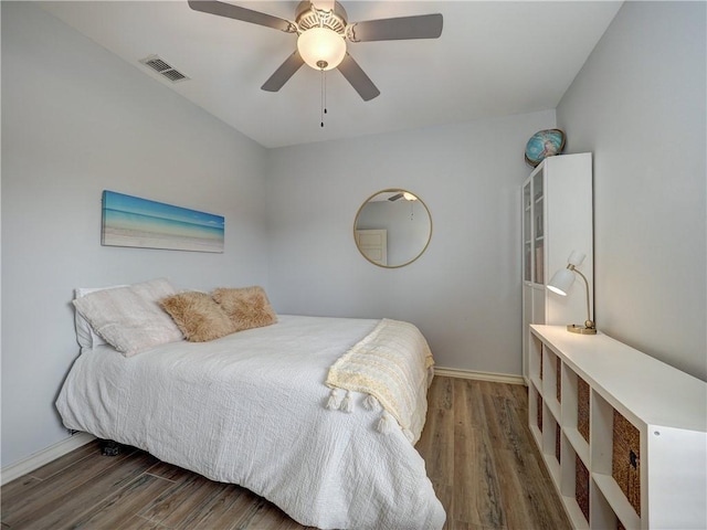 bedroom with wood finished floors, baseboards, and a ceiling fan