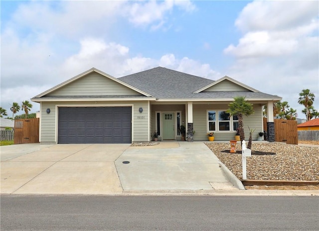 15101 Tesoro Dr, Corpus Christi, TX 78418 - view of front of home featuring an attached garage, concrete driveway, roof with shingles, and a porch