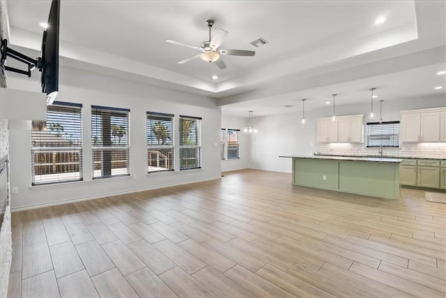 15101 Tesoro Dr, Corpus Christi, TX 78418 - kitchen featuring open floor plan, ceiling fan, a raised ceiling, decorative backsplash, and recessed lighting