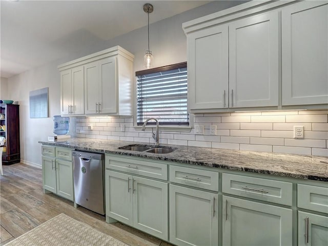 kitchen with a sink, dishwasher, decorative backsplash, stone counters, and light wood-style floors