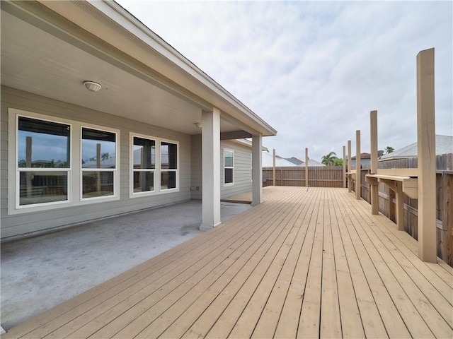 wooden terrace featuring fence