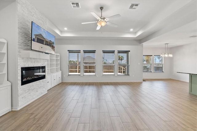 15101 Tesoro Dr, Corpus Christi, TX 78418 - unfurnished living room featuring a ceiling fan, plenty of natural light, a stone fireplace, light wood finished floors, and recessed lighting