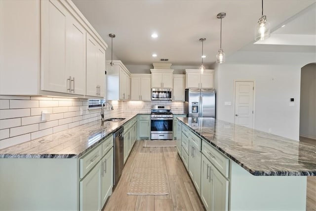 15101 Tesoro Dr, Corpus Christi, TX 78418 - kitchen with stainless steel appliances, a spacious island, dark stone counters, backsplash, and recessed lighting
