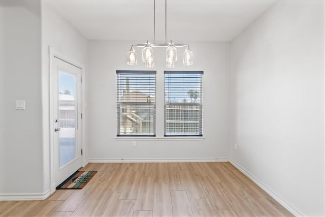 15101 Tesoro Dr, Corpus Christi, TX 78418 - unfurnished dining area with light wood finished floors and a chandelier