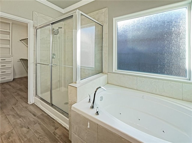 bathroom featuring wood-type flooring, independent shower and bath, and ornamental molding