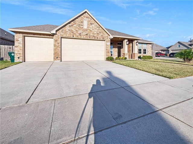 view of front of property with a front yard and a garage