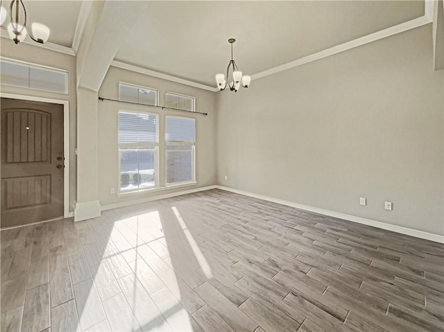 unfurnished dining area featuring a notable chandelier, wood-type flooring, and ornamental molding