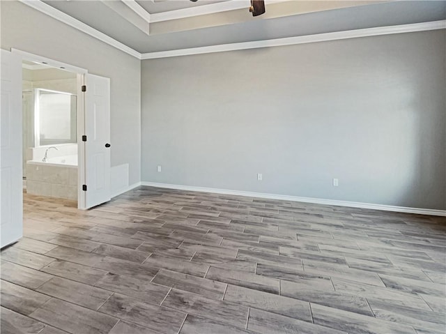 empty room with crown molding and light hardwood / wood-style flooring