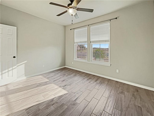 unfurnished room with ceiling fan and light wood-type flooring