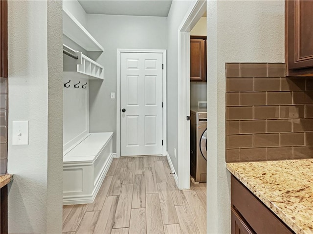 mudroom with washer / clothes dryer and light hardwood / wood-style flooring