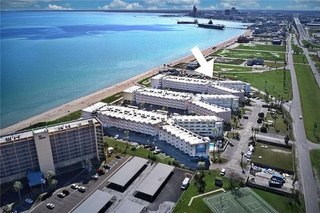 drone / aerial view featuring a water view and a beach view