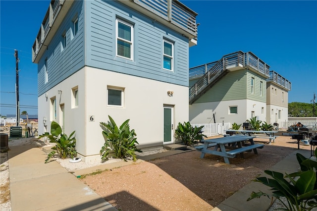 rear view of house featuring cooling unit and a patio area