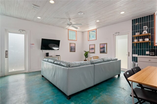 living room with a wealth of natural light and ceiling fan