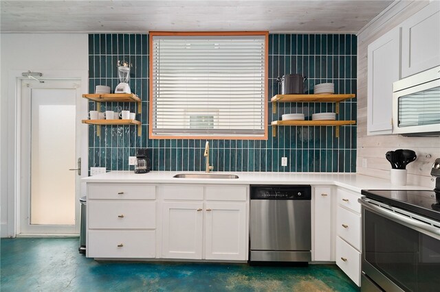 kitchen with stainless steel appliances, white cabinets, sink, and decorative backsplash