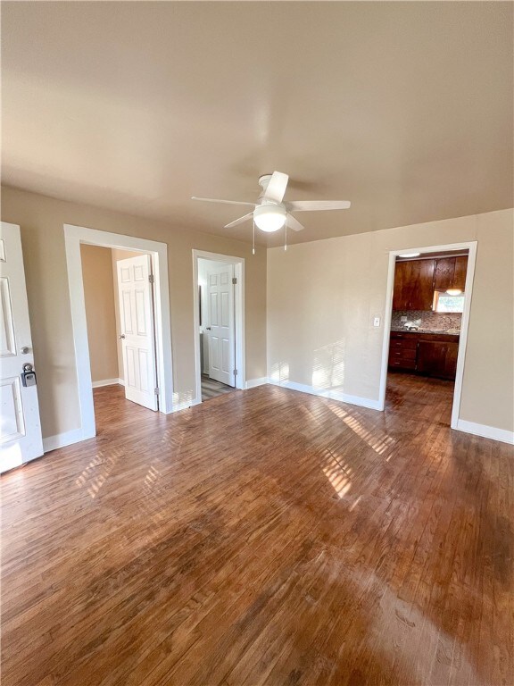 interior space featuring wood-type flooring and ceiling fan