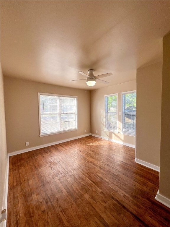 spare room featuring dark hardwood / wood-style flooring and ceiling fan