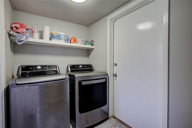 washroom with light tile patterned floors and separate washer and dryer