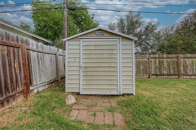 view of outdoor structure featuring a lawn