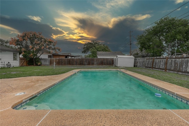 pool at dusk featuring a lawn