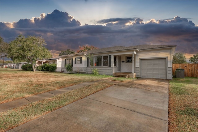 ranch-style house featuring a garage and a lawn