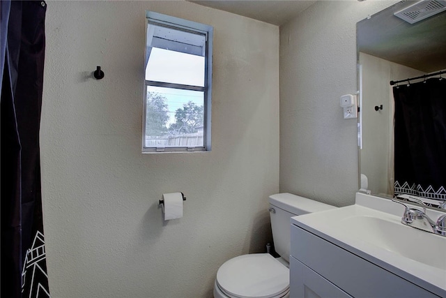 bathroom featuring vanity and toilet