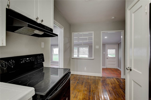 kitchen featuring white cabinetry, dark hardwood / wood-style flooring, and black range with electric stovetop