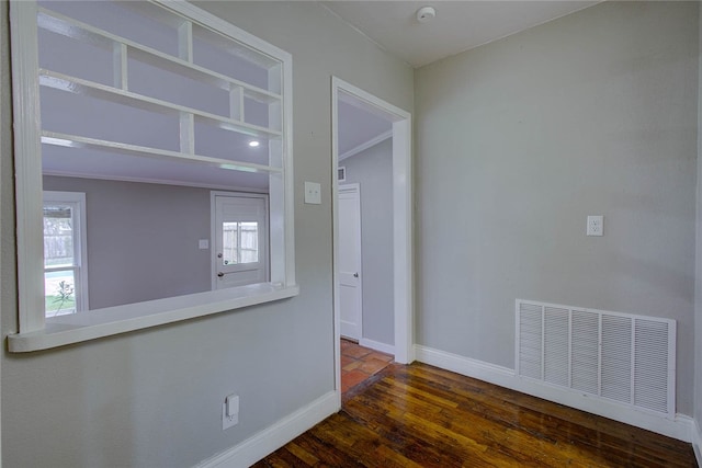 unfurnished room with dark hardwood / wood-style flooring and crown molding